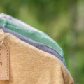 Organic,Clothes.,Natural,Colored,T-shirts,Hanging,On,Wooden,Hangers,In