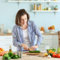 Young,Woman,Making,Salad,In,Kitchen